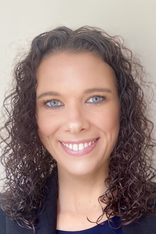 Megan Ranzenhofer smiling, standing with white background